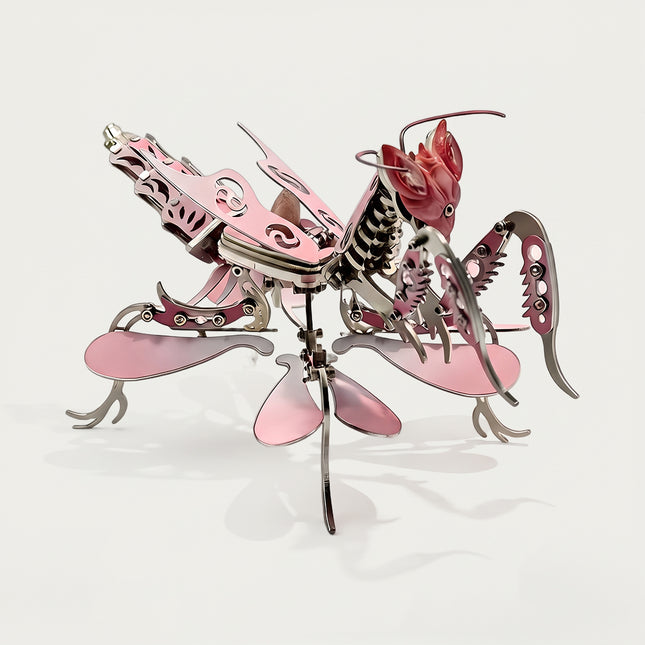 Fully assembled pink steampunk puzzle praying mantis, designed as a 3D metal model desk accent.