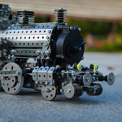 Vintage steampunk puzzle metal model of a mechanical steam locomotive engine close-up