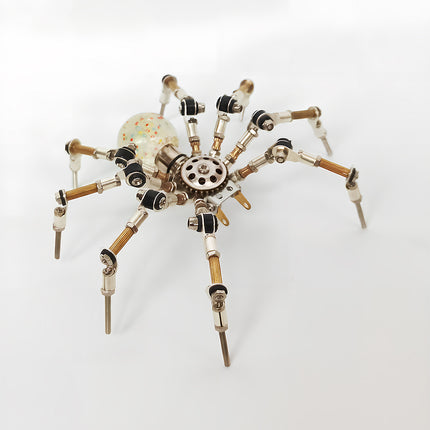 An impressive steampunk puzzle spider model featuring articulated legs, a gear-shaped thorax, and a unique translucent abdomen filled with colorful specs. This captivating metal model built from 3D puzzle Metal Kits makes a fantastic mechanical steampunk / steam punk mech decoration for any desk.
