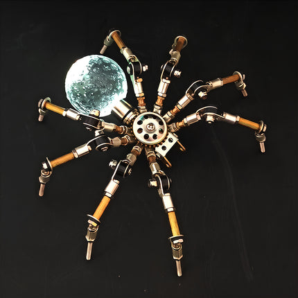 A dramatic top-down view of the steampunk puzzle spider model against a dark background, highlighting an intense bright white glowing spherical abdomen. This exquisite metal model built from 3D puzzle Metal Kits features multi-jointed metallic legs and exceptional mechanical steampunk / steam punk mech design.