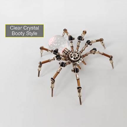 Product feature view of the steampunk puzzle spider model, highlighting a "Clear Crystal Booty Style" text overlay pointing to its glowing translucent sphere abdomen. This creative metal model built from 3D puzzle Metal Kits showcases intricate articulated legs and brilliant mechanical steampunk / steam punk mech design details.