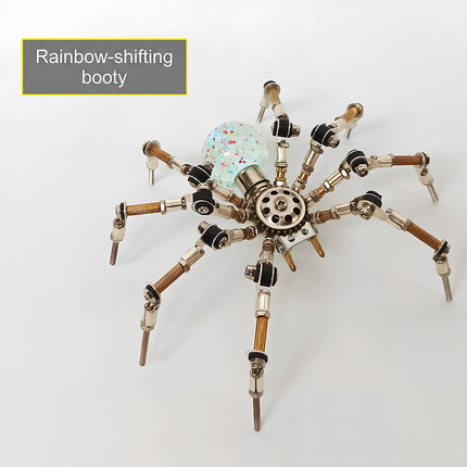Product feature view of the steampunk puzzle spider model, showcasing a "Rainbow-shifting booty" text overlay pointing to its colorful speckle-filled translucent sphere abdomen. This creative metal model built from 3D puzzle Metal Kits combines articulated legs and sophisticated mechanical steampunk / steam punk mech details into a striking showcase piece.