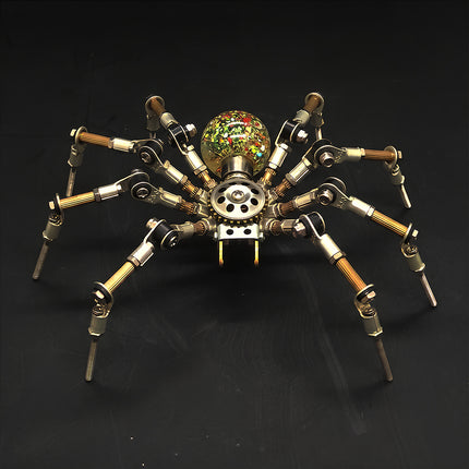 A front-angle view of the steampunk puzzle spider model against a dark background, showcasing its unique translucent spherical abdomen filled with colorful speckles and confetti details. This stunning metal model built from precision 3D puzzle Metal Kits highlights intricate multi-jointed legs and an exceptional mechanical steampunk mech design.