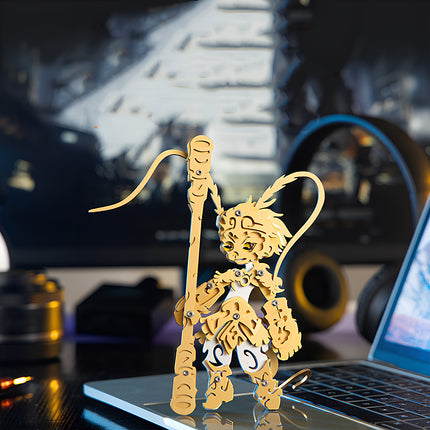 Sun Wukong steam punk mech metal model on laptop for tech desk setup.