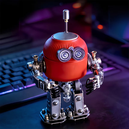 A finished steam punk mech metal model standing on a desk next to a keyboard, showcasing its intricate mechanical details.