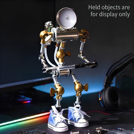 A creative desktop lifestyle photo of a steampunk puzzle robot metal model with a headlamp and blue sneakers in a gaming setup.