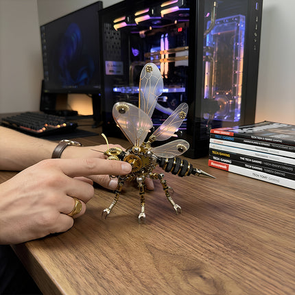 Large metal model wasp with translucent wings on a tech desk, a premium mechanical steampunk decor piece for gaming setups.