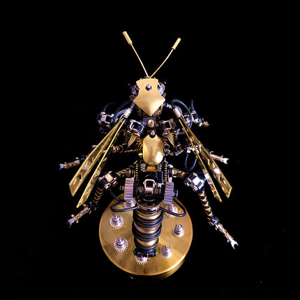 Top-down view of steampunk bumblebee 3D puzzle metal model, a meticulously crafted mechanical steampunk figure with golden wings and antenna, displayed on a dark background.