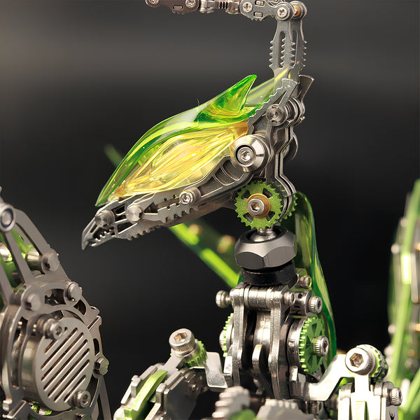 Macro shot of a green **3D metal puzzle** mantis featuring a translucent acrylic head and stainless steel neck gears.